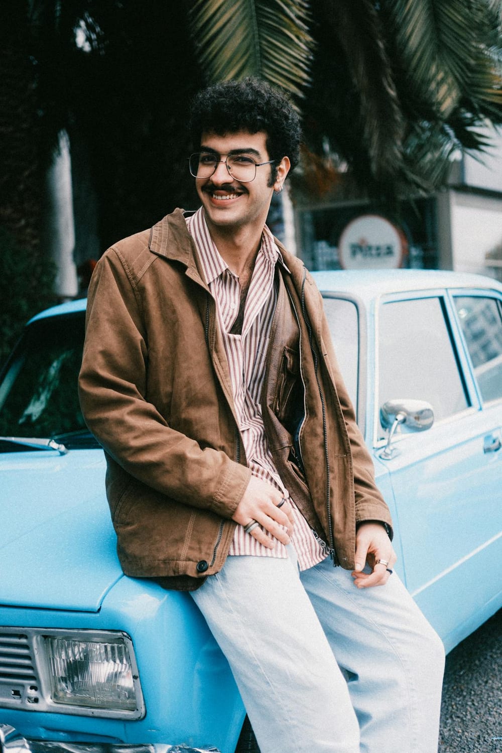 Smiling man in casual attire sitting