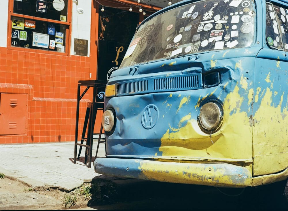 A distressed blue and yellow van