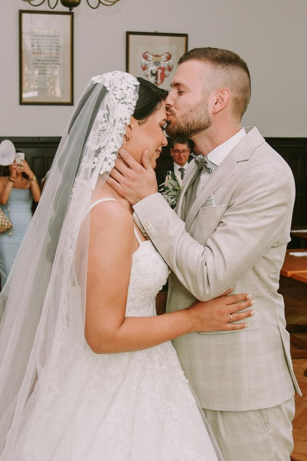 Bride and groom share a tender kiss