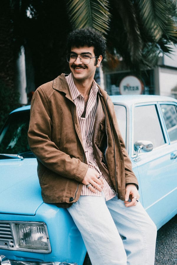 Smiling man in casual attire sitting